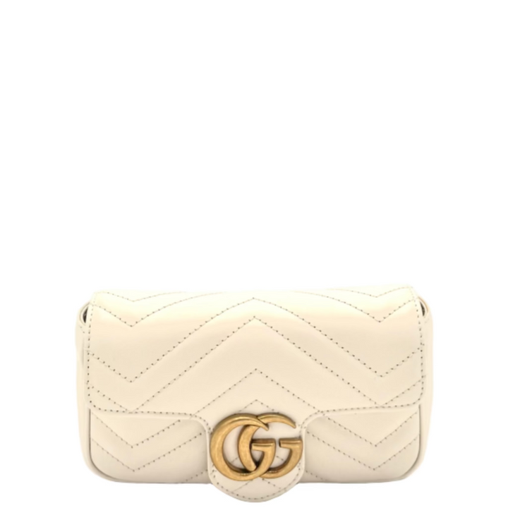 Gucci cream quilted handbag with a gold logo on a white background