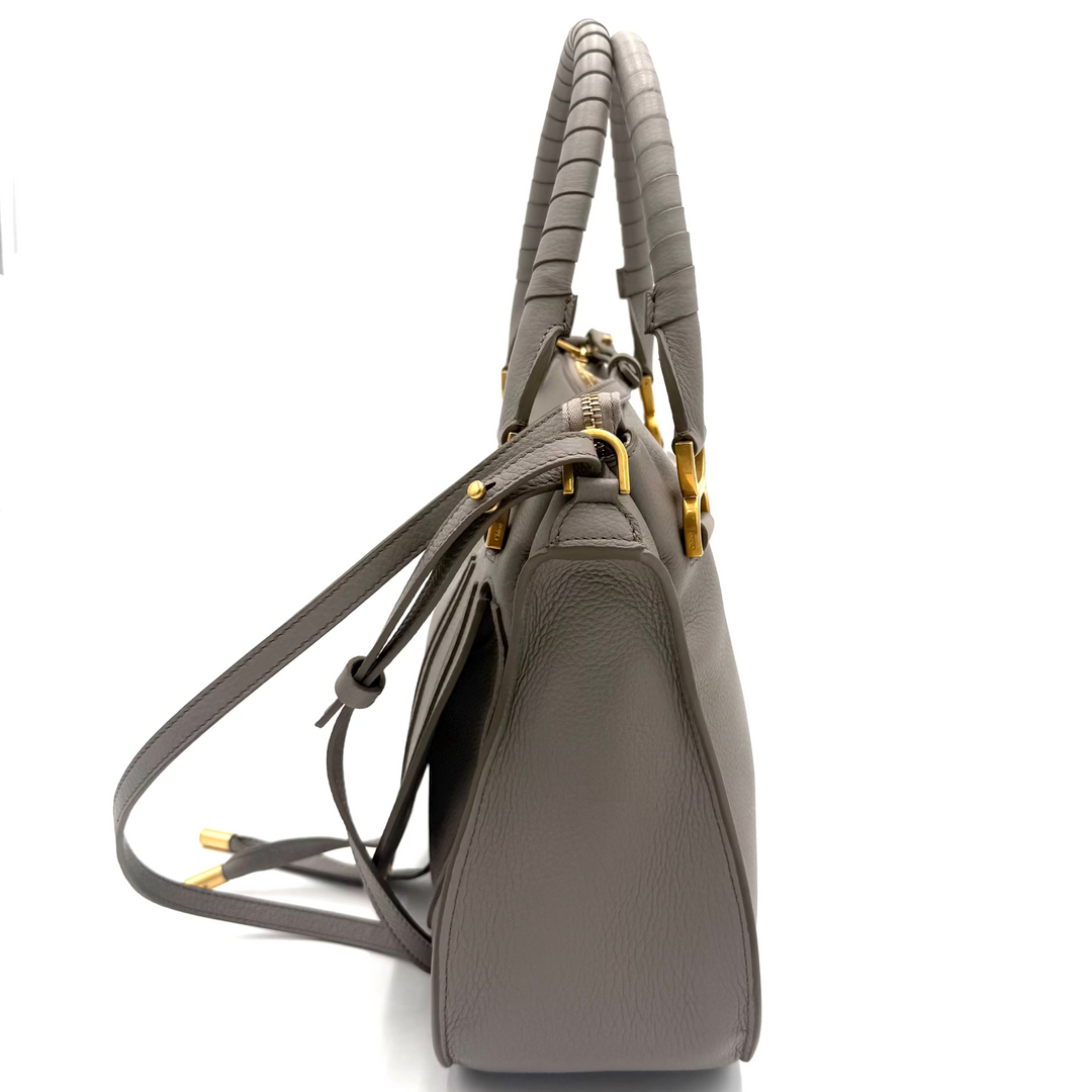 A structured gray leather handbag with a braided top handle and gold-tone hardware, shown from a side profile view on a white background.